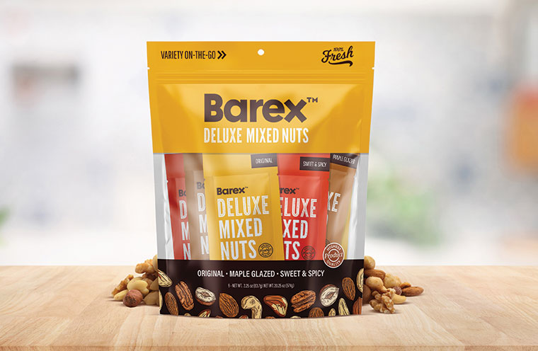 stand up pouch with nut wrappers inside surrounded by mixed nuts