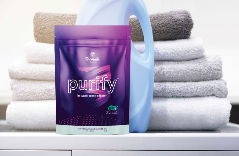 purple detergent pouch on washing machine with towels
